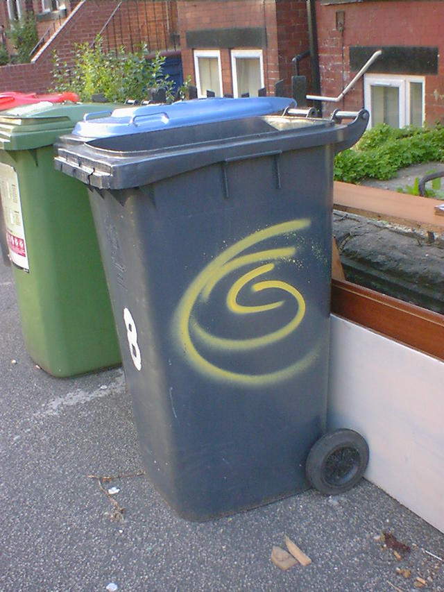 Yellow Spiral s[ray-paintes on a Wheelie Bin